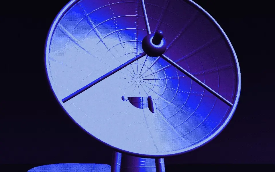 A blue radar dish against a dark sky